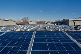 Installation of the solar photovoltaic system on the roof of the Museum’s Collections Research Center. Photo taken February 2013.