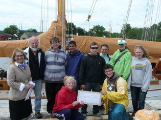 Students coming off a week of sail training aboard schooner Brilliant present Mystic Seaport with a gift of support.