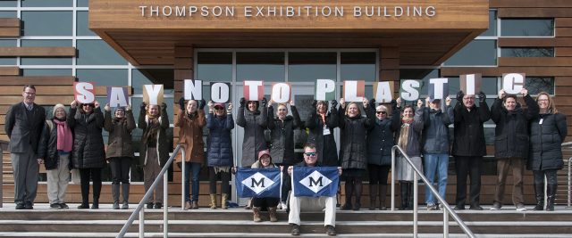Museum staff members gather on the steps of the Thompson Exhibition Building to get out the "Say No to Plastics" message.