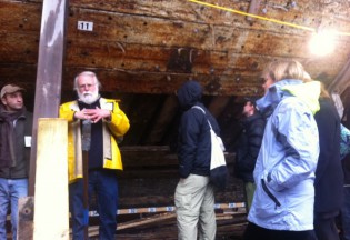 Mystic Seaport Shipyard Director Quentin Snediker (in yellow) discusses the Morgan project with scholars.